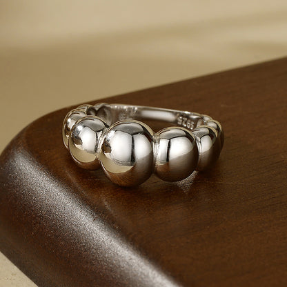 “Flat lay of S925 sterling silver geometric dome ring with mirror polish”