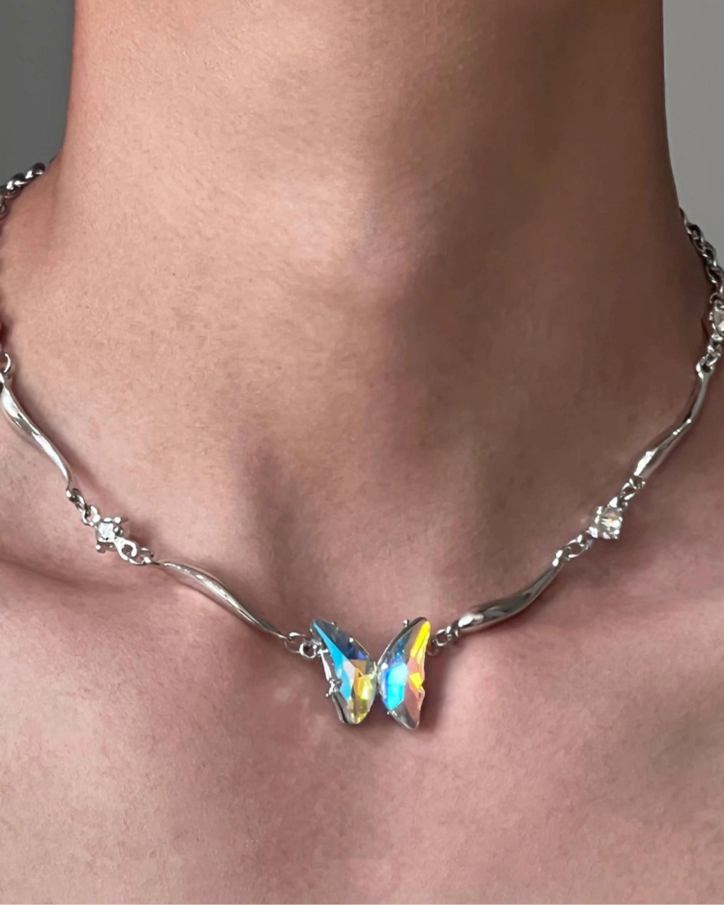 “Cool-sweet aesthetic styling with sculptural butterfly necklace”