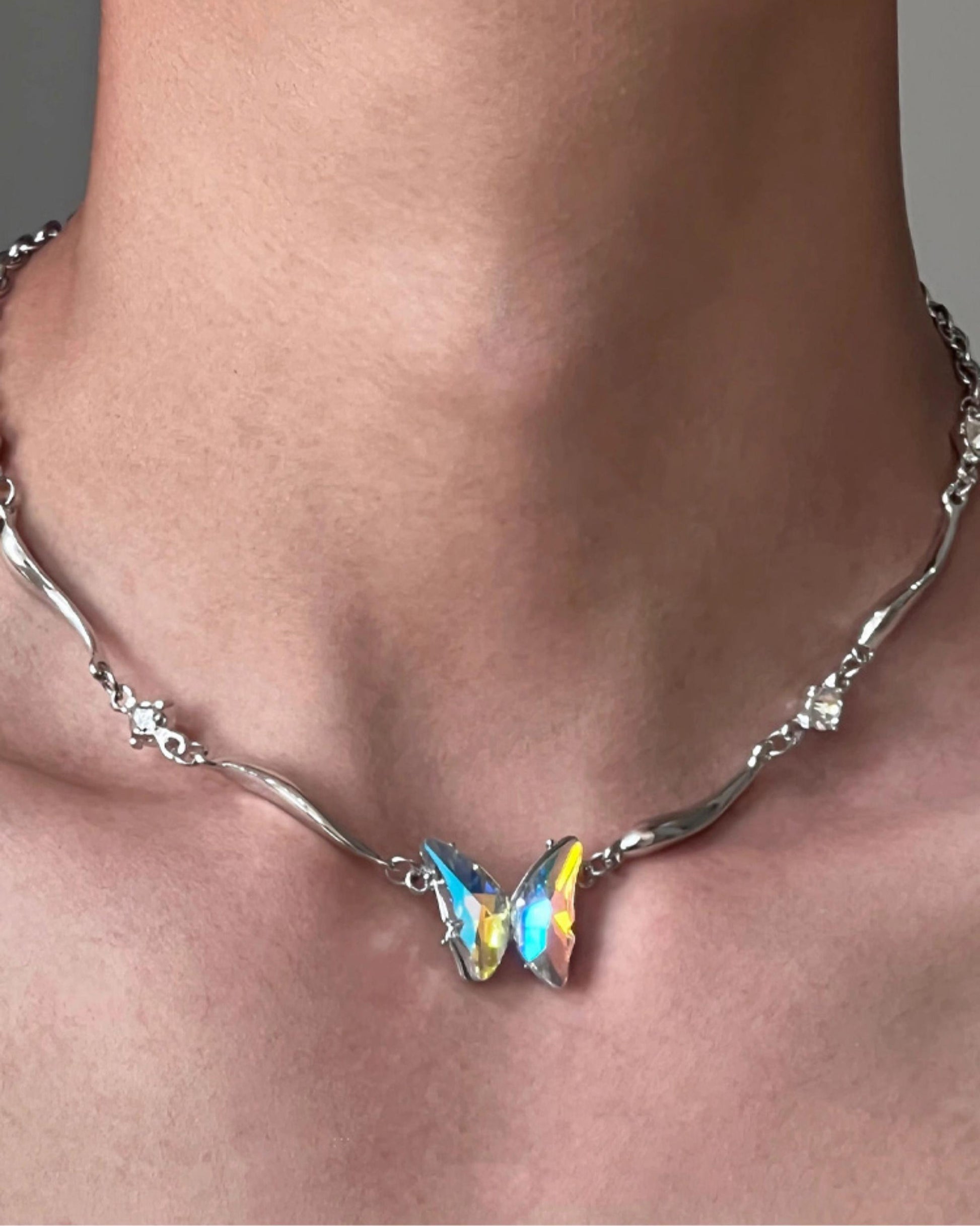 “Cool-sweet aesthetic styling with sculptural butterfly necklace”