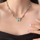 “Female model layering irregular metal butterfly necklace for streetwear look”