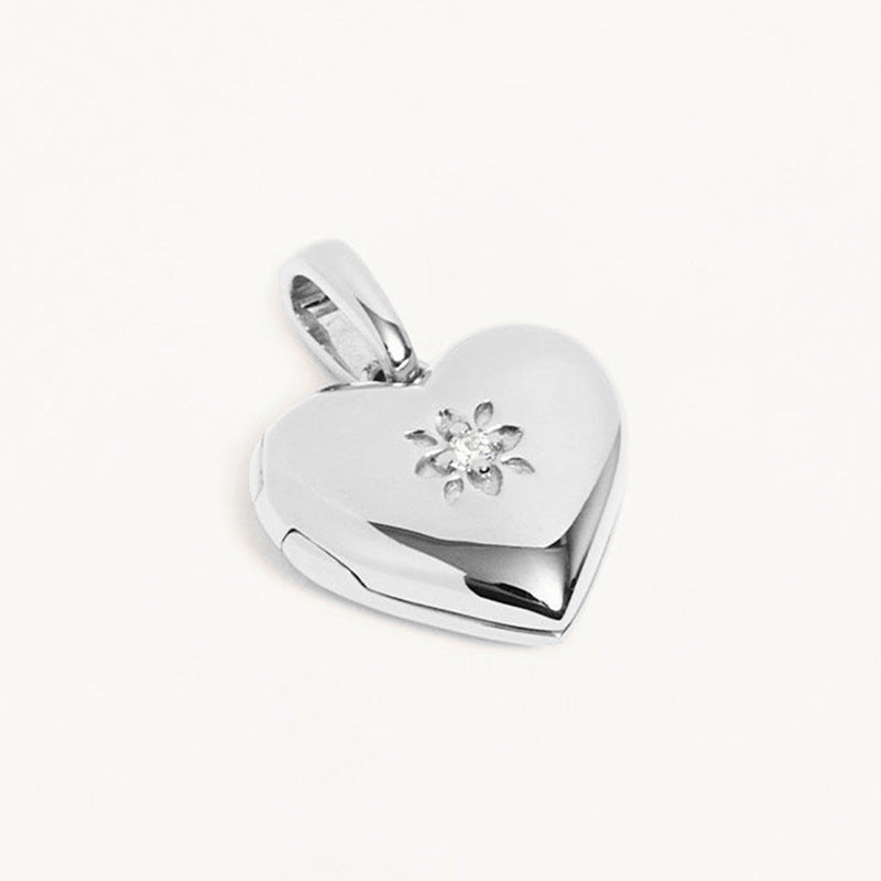 “S925 sterling silver heart locket pendant flat lay on white background”