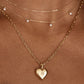 “Elegant woman wearing minimalist heart locket pendant necklace”