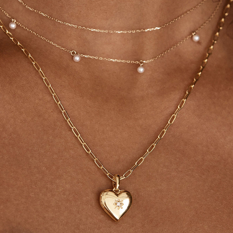 “Elegant woman wearing minimalist heart locket pendant necklace”