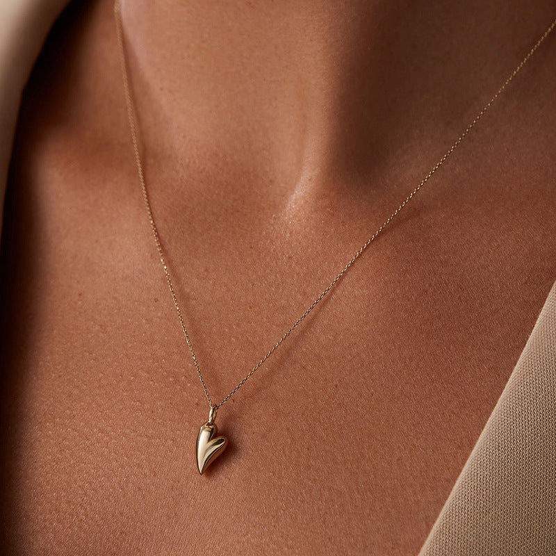 “Side view of dainty heart pendant necklace for women”