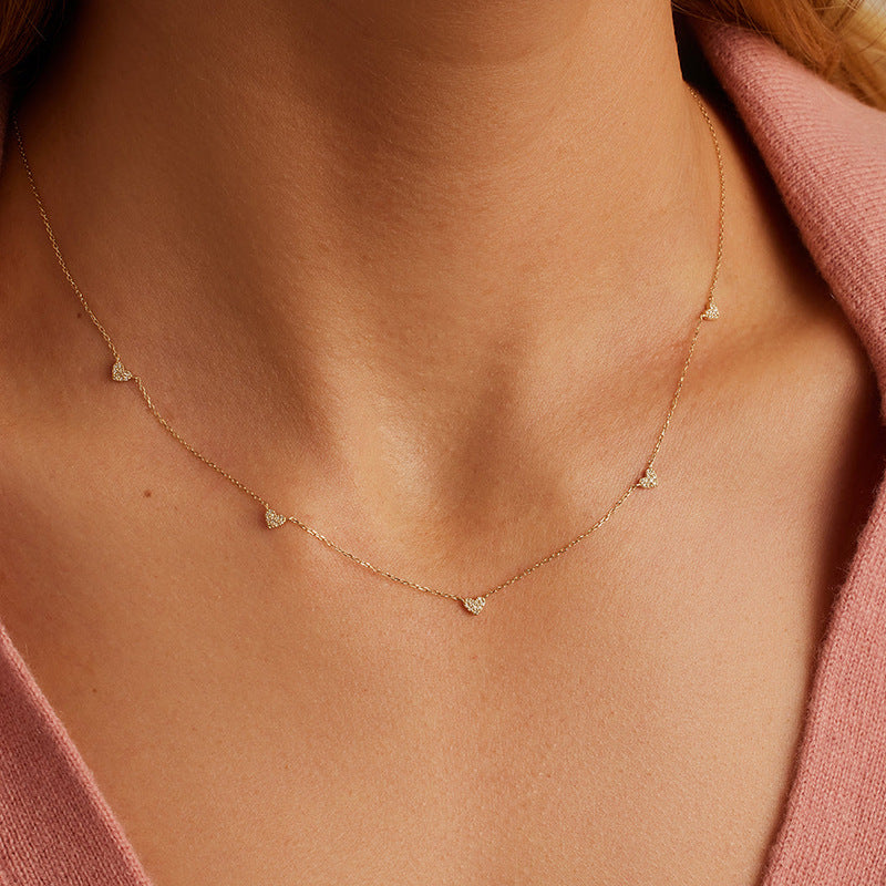 “Woman wearing elegant S925 silver heart pendant necklace, dainty romantic style”