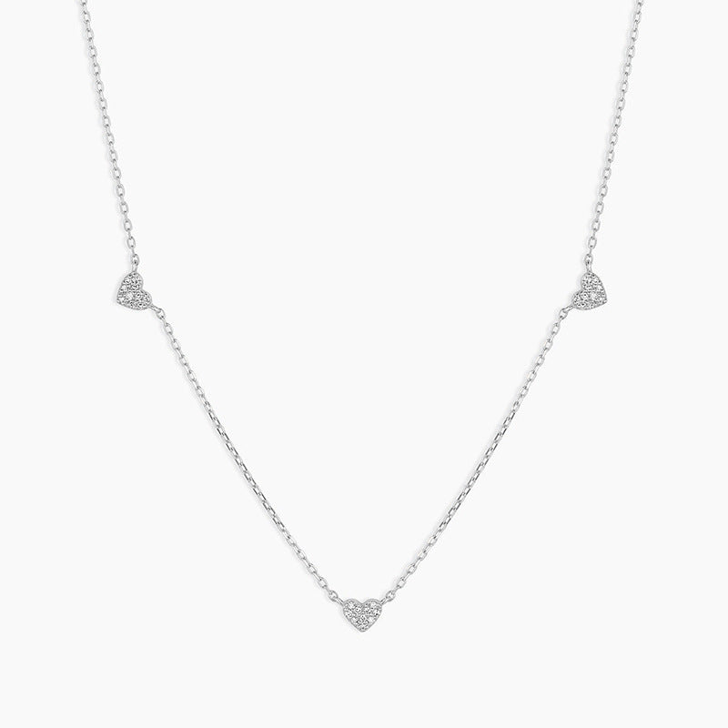 “Flat lay of S925 sterling silver heart pendant necklace with cubic zirconia stone”