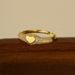 “Flat lay of S925 sterling silver heart signet ring with micro pave cubic zirconia”