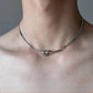 Male model wearing knotted snake bone silver chain necklace”