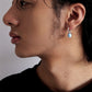 “Unisex Larimar drop earrings styled with streetwear on male model”