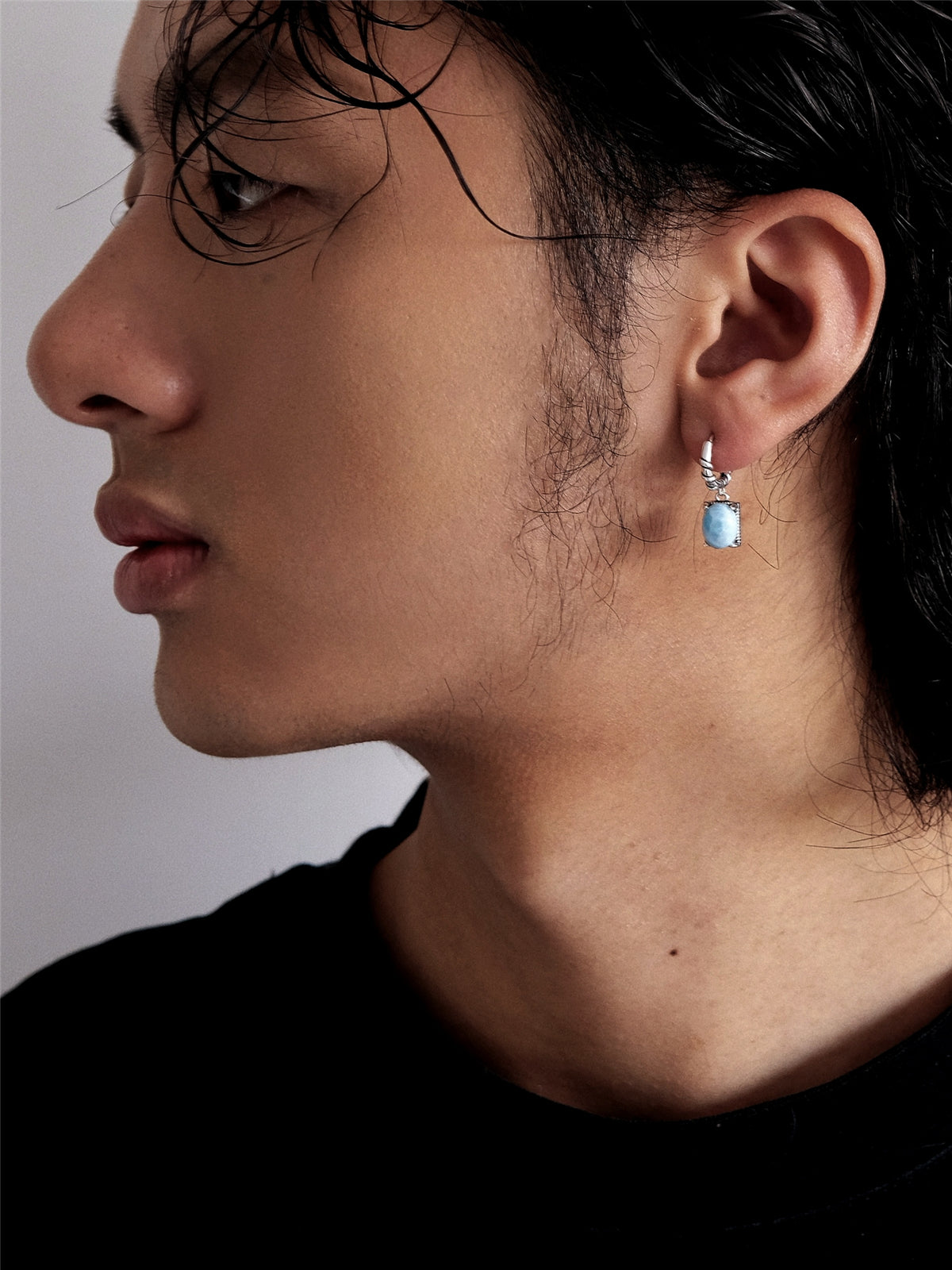 “Unisex Larimar drop earrings styled with streetwear on male model”