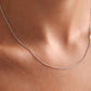 “Woman wearing minimalist S925 sterling silver mixed chain and pearl necklace”