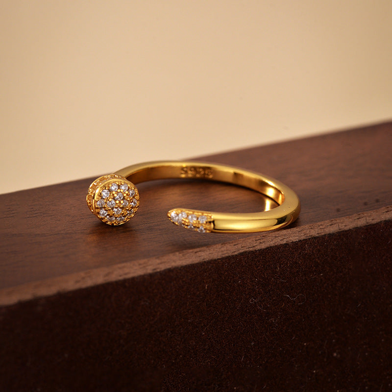 “Flat lay of S925 sterling silver nail design ring with micro-pavé zircon stones”