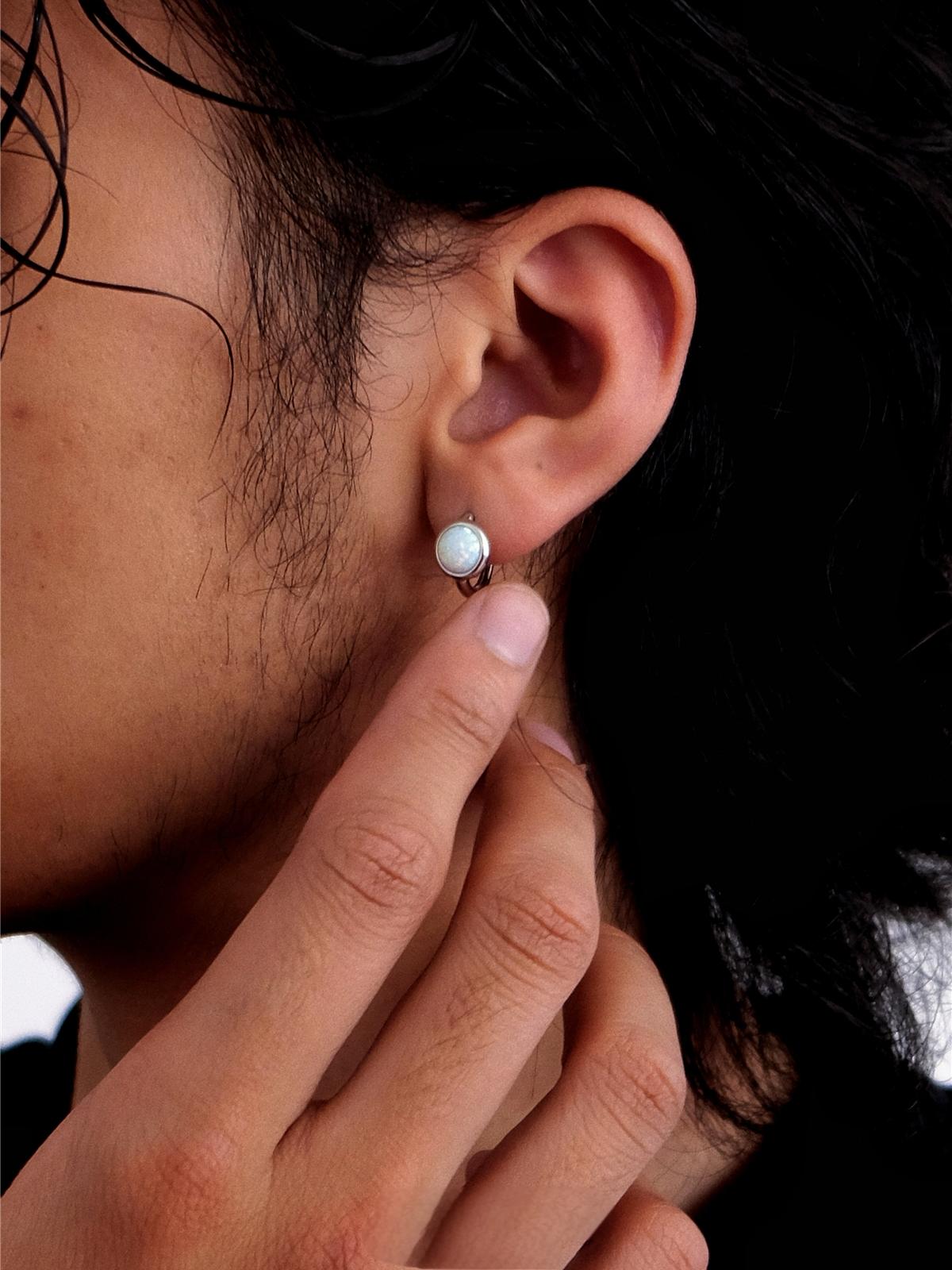 opal ear hoops styled with modern clean luxury look