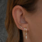 Close-up of an ear wearing S925 Sterling Silver Palma Charm Earring with a blurred background