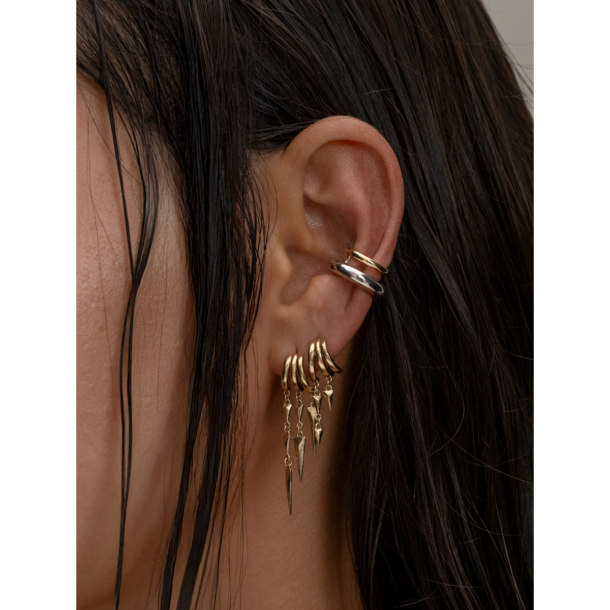 S925 Sterling Silver Paloma Illusion Earrings earrings and ring on an ear with dark hair