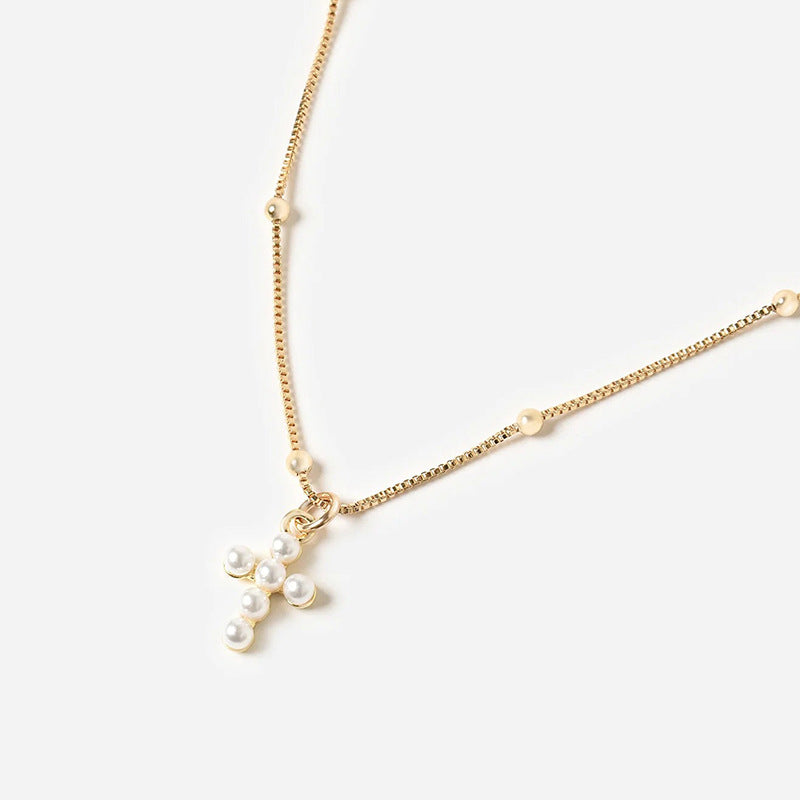 Close-up of Silver Cross Pendant and Chain Texture