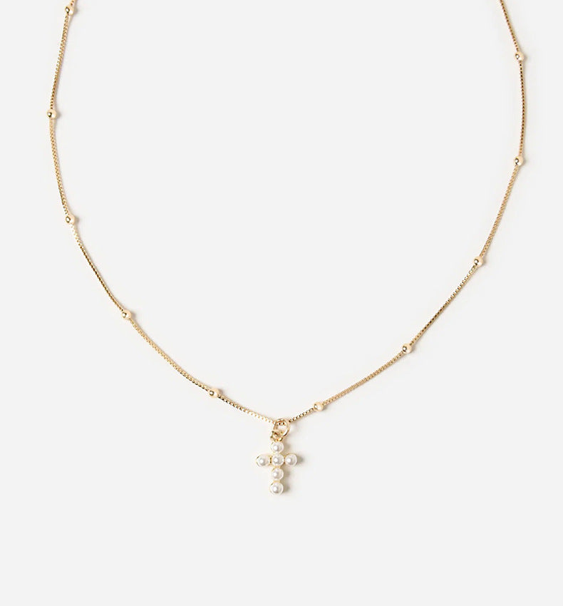 Close-up of Silver Cross Pendant and Chain Texture