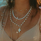 Woman Wearing Minimalist Silver Cross Necklace
