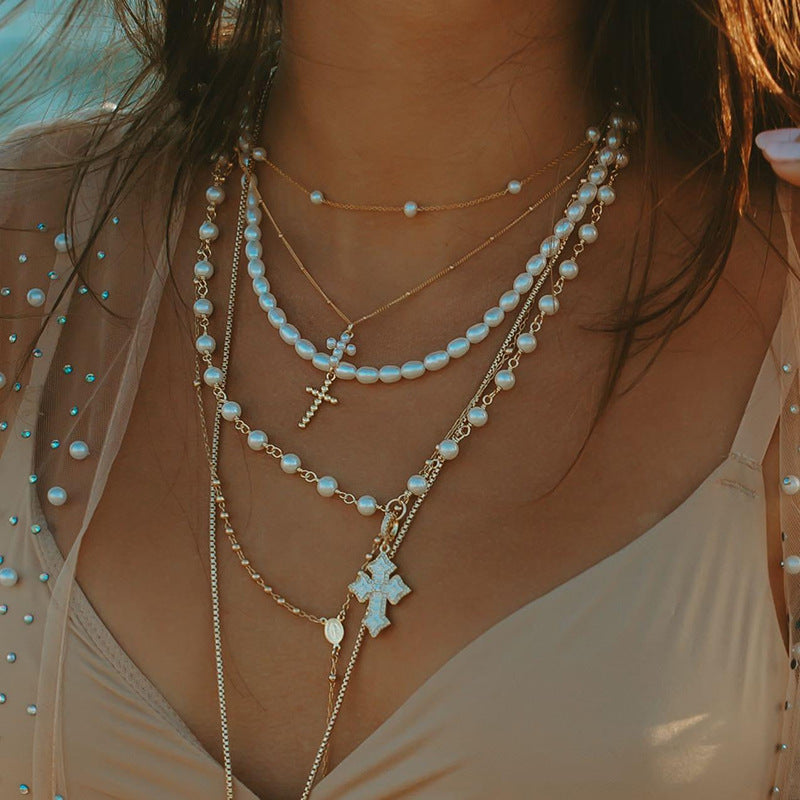 Woman Wearing Minimalist Silver Cross Necklace