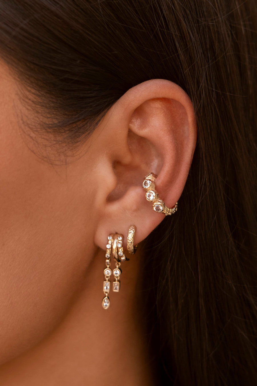 S925 Sterling Silver Petra Stacked Illusion EarringsClose-up of an ear wearing gold earrings with small stones.