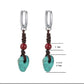 “Handcrafted raw turquoise cinnabar earrings worn with boho outfit”