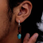 “Handcrafted raw turquoise cinnabar earrings worn with boho outfit”