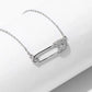 “Close-up of micro-pavé zircon safety pin pendant in polished silver finish”