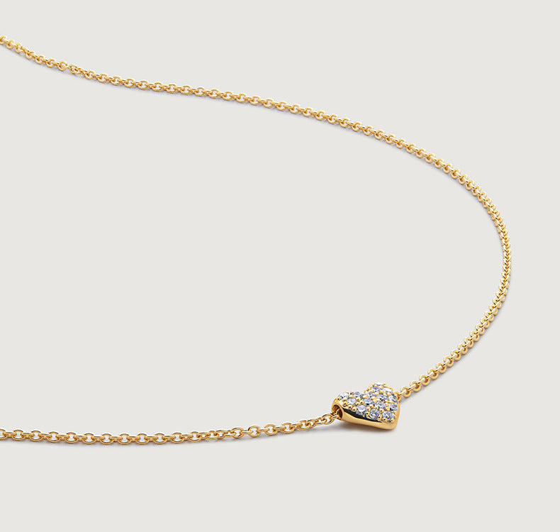 “Close-up of CZ diamond heart pendant on adjustable sterling silver chain”