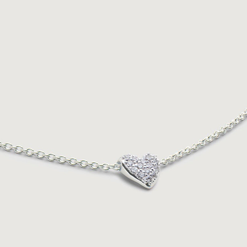 “Close-up of CZ diamond heart pendant on adjustable sterling silver chain”