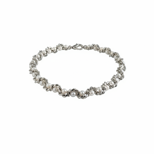 close-up of serpent-style silver choker texture and layered chain contrast”