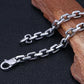 Silver chain with clasp on a dark background