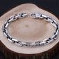 Silver chain bracelet on a wooden surface