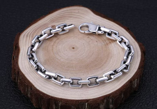 Silver chain bracelet on a wooden surface