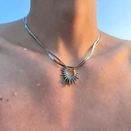 “men’s minimalist silver sun god necklace styled with cold aesthetic outfit”