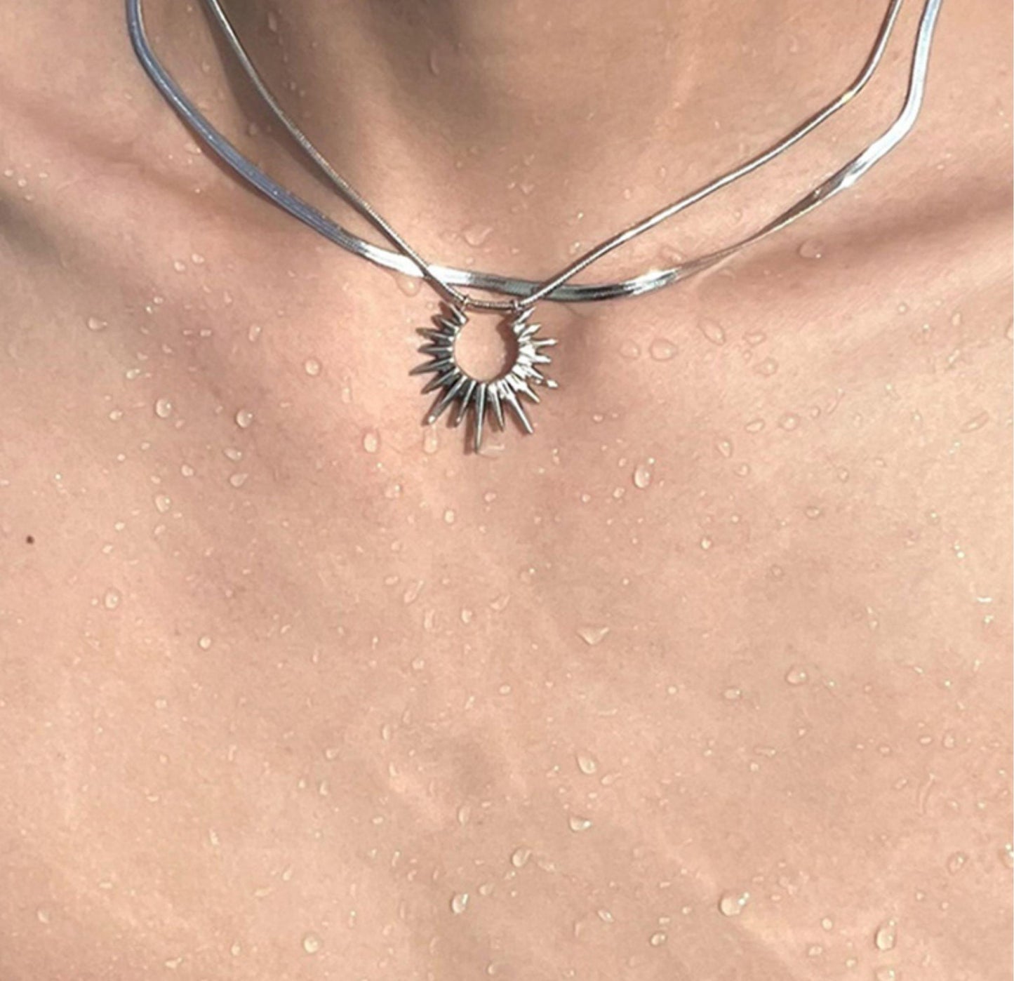 “men’s minimalist silver sun god necklace styled with cold aesthetic outfit”