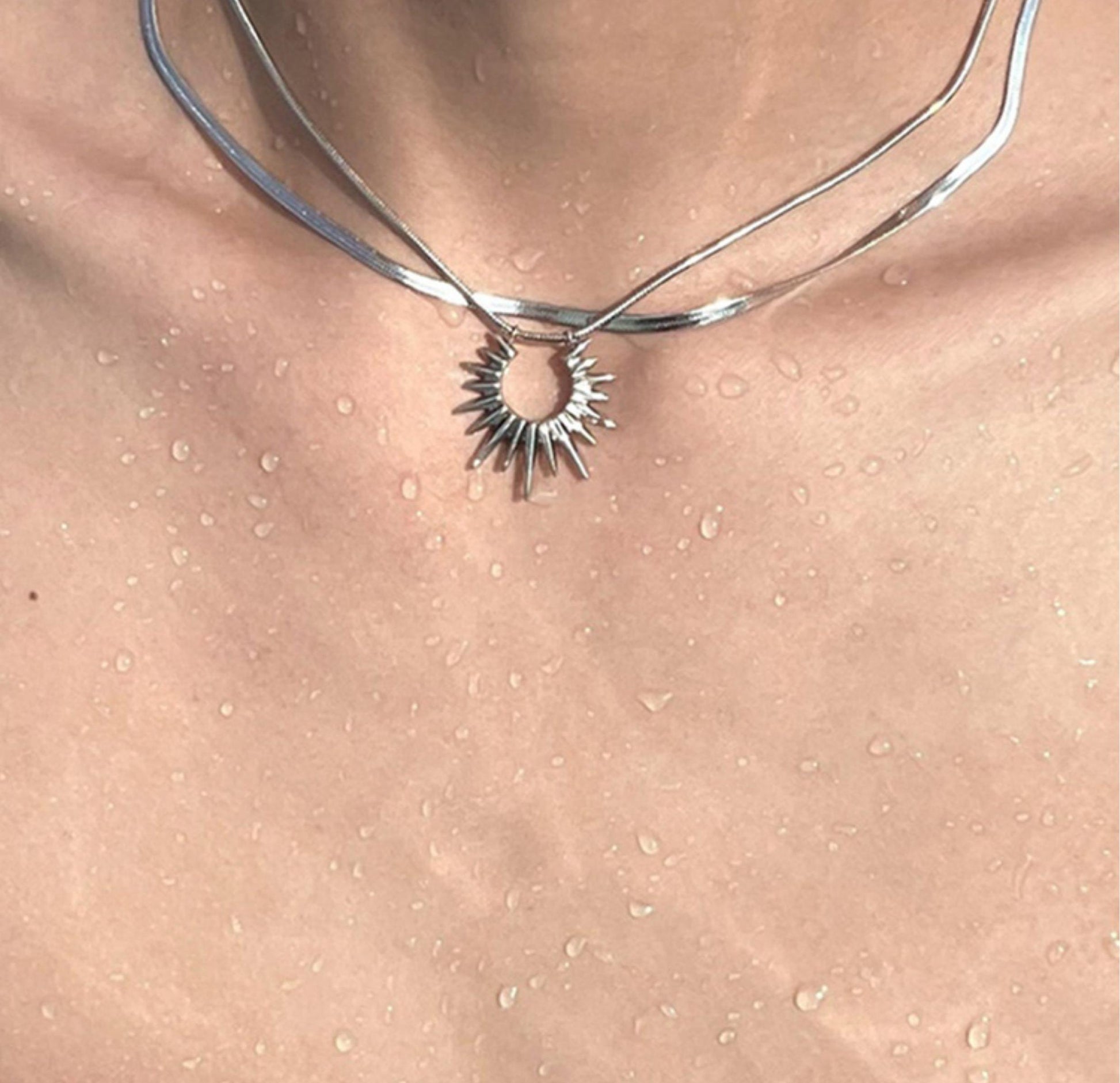 “men’s minimalist silver sun god necklace styled with cold aesthetic outfit”