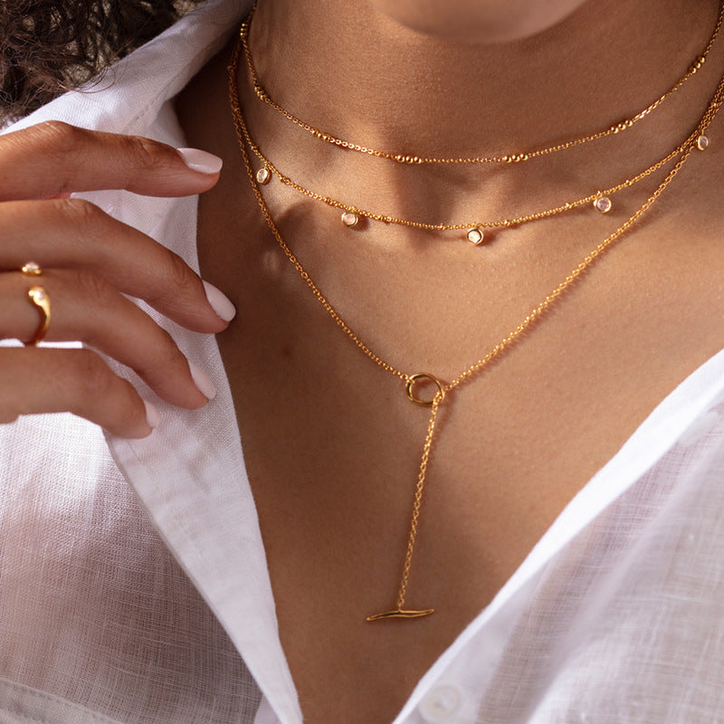 Woman Wearing Minimalist Silver OT Necklace