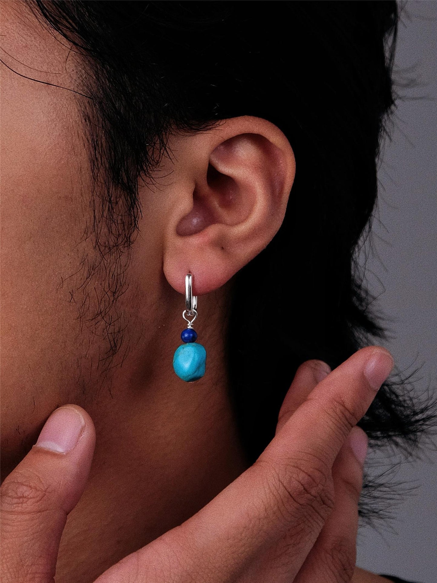 “Unisex Tibetan-style turquoise lapis earrings worn by model”