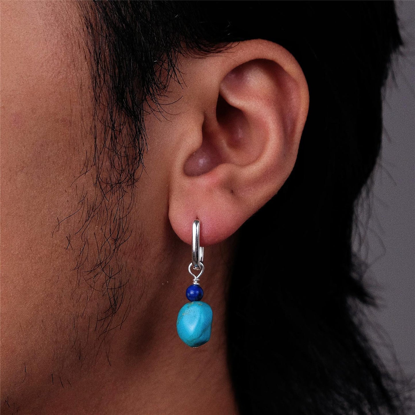 “Unisex Tibetan-style turquoise lapis earrings worn by model”
