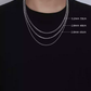 Three silver necklaces of different thicknesses worn on a black shirt with measurements displayed.