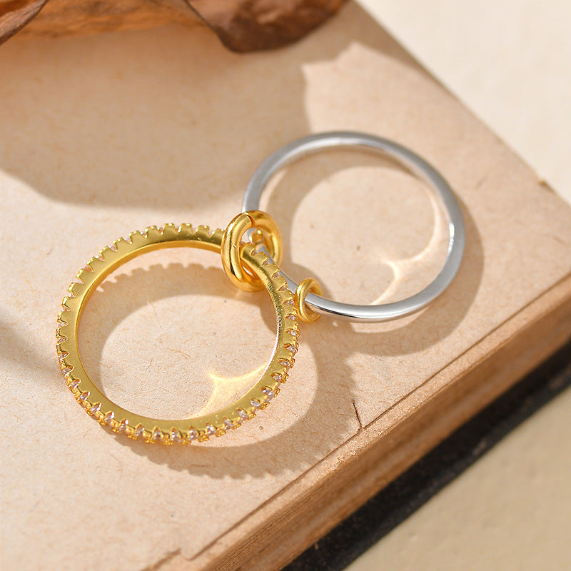 “Close-up of micro-paved zircon stones and two-tone silver gold layers on ring”