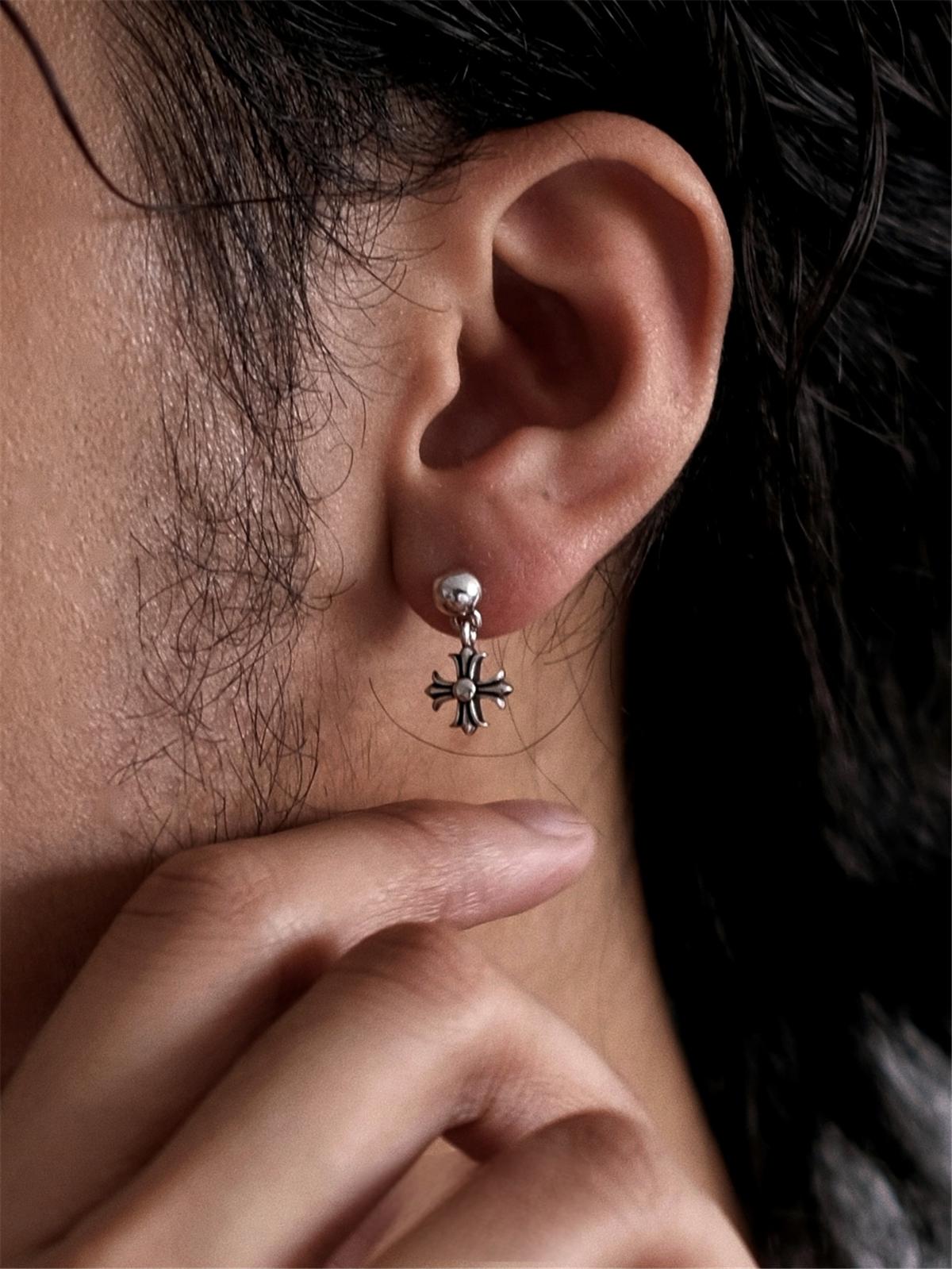 model wearing vintage distressed cross earring punk street style