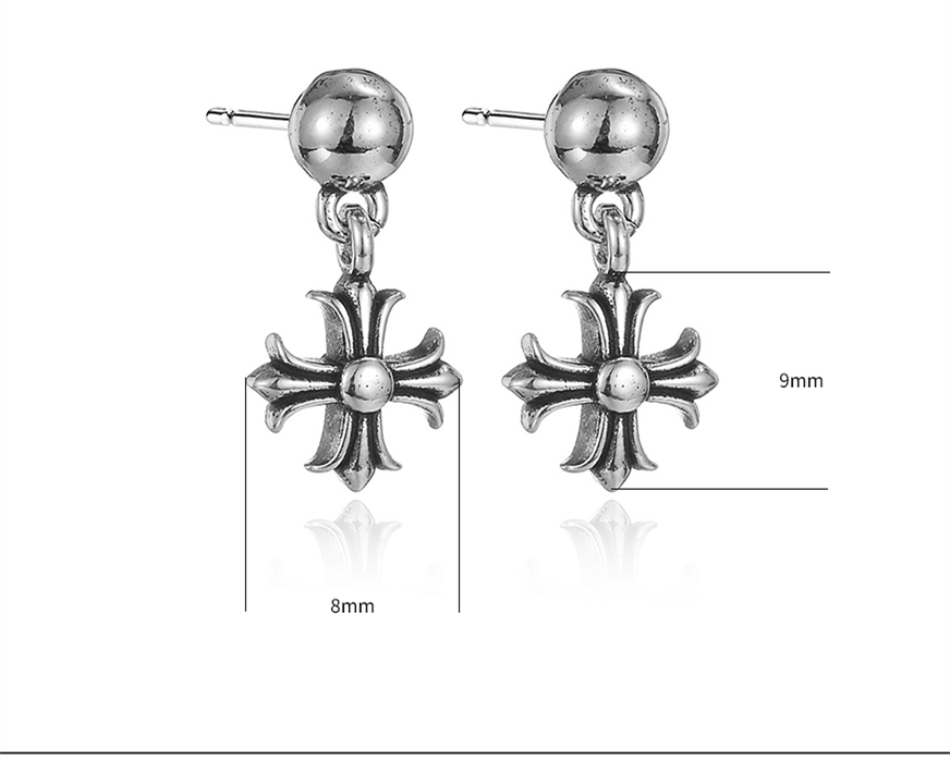 macro shot of rustic punk cross earring surface design