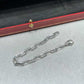 “Santos de Cartier chain bracelet medium model flat lay”