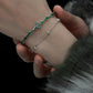 "Female model styling cold-tone snake bracelet with elegant sweet-cool look"