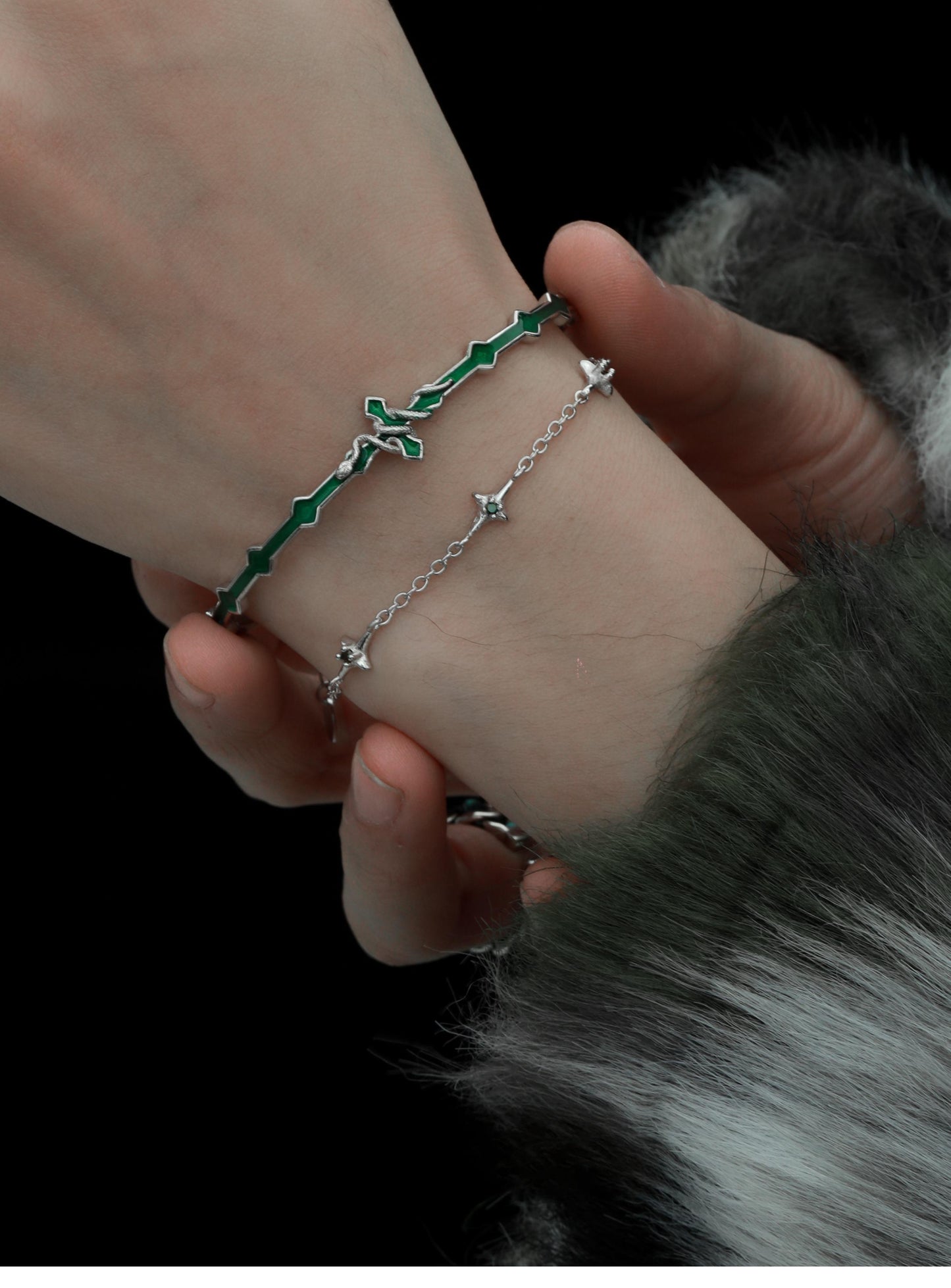 "Female model styling cold-tone snake bracelet with elegant sweet-cool look"