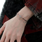 "Male model wearing serpent-inspired sterling silver bangle in minimalist style"
