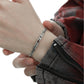 "Model wearing sleek unisex silver serpent bracelet styled in minimalist fashion"