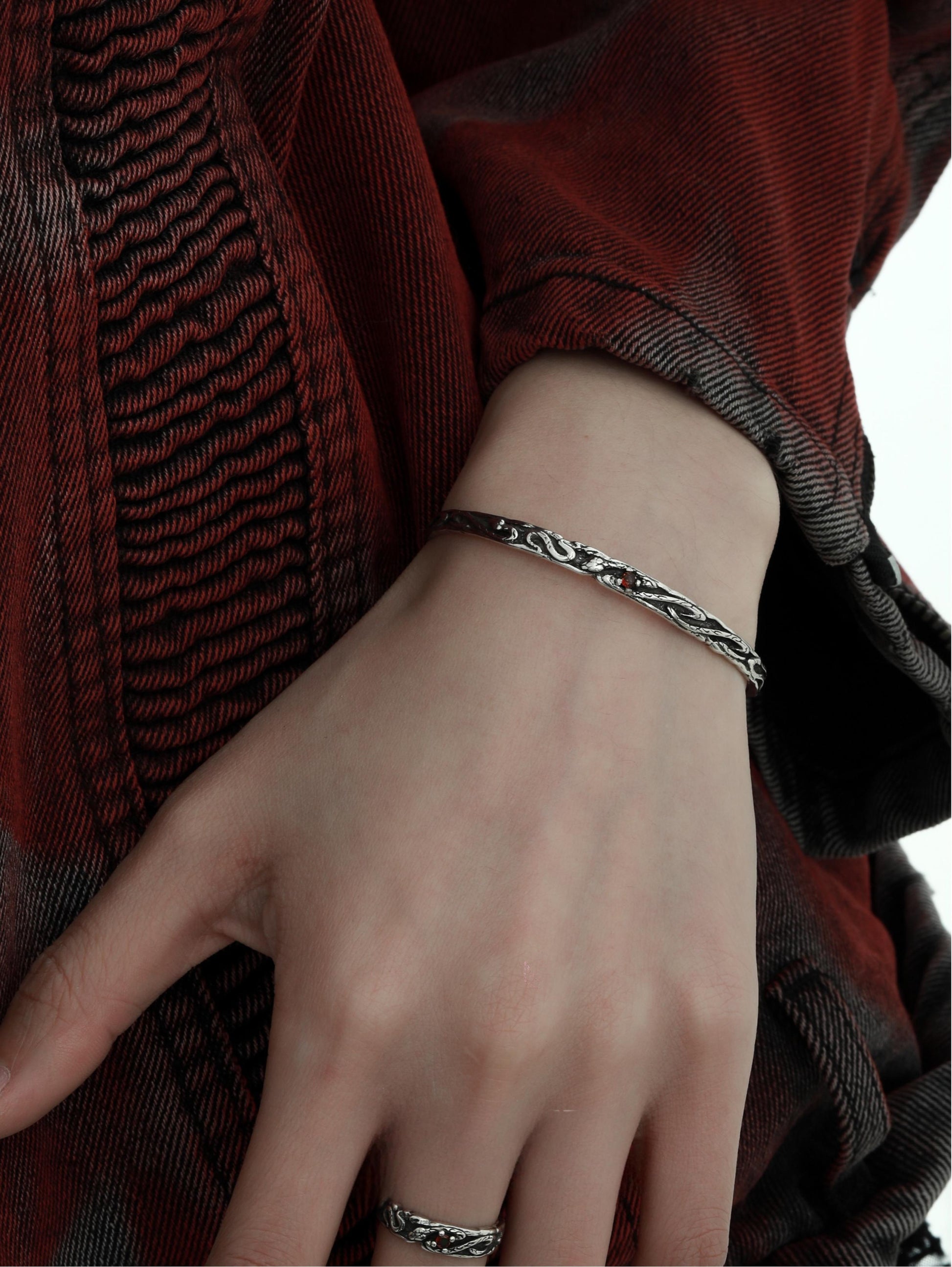 "Model wearing sleek unisex silver serpent bracelet styled in minimalist fashion"