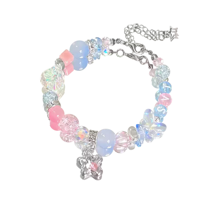 Colorful beaded bracelet with butterfly charms on a white background